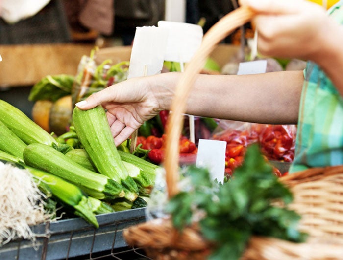 A hand reaching for produce