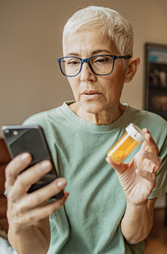 Patient looking up information about her bottled perscription on her phone