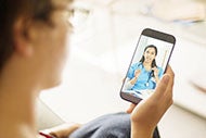 A patient talks to a doctor via Facetime on a phone during a telehealth visit